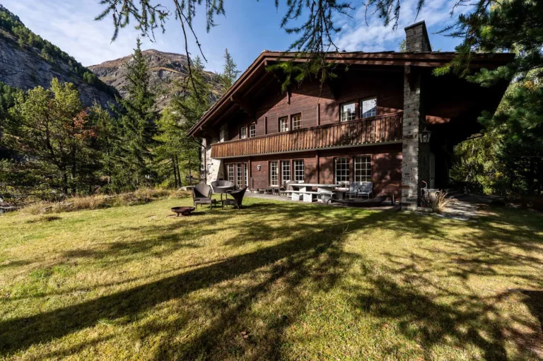 the chalet from outside with trees