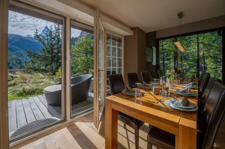 dining table with view and a door into the garden