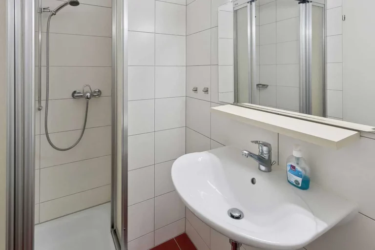 a bathroom with a shower and sink