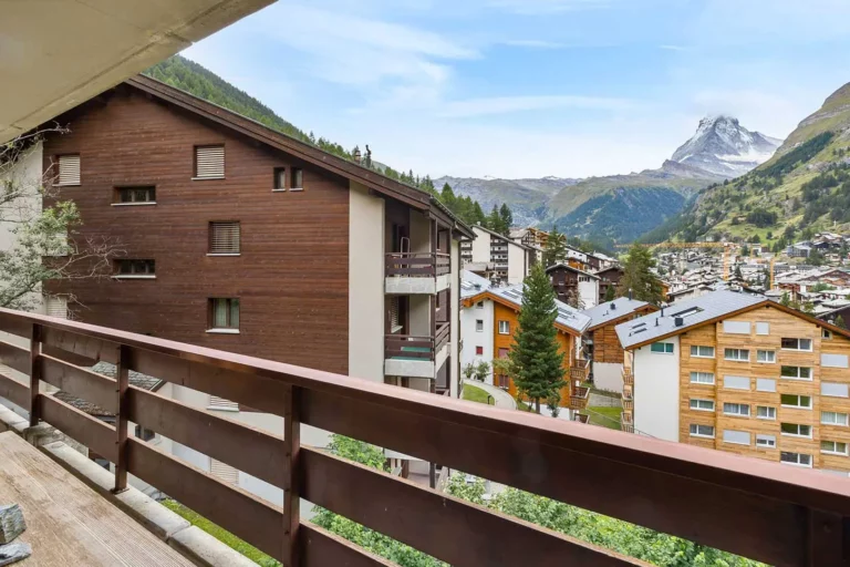 a balcony with a view of a town and mountains