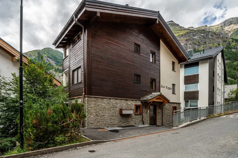 a building with a stone wall and a stone walkway